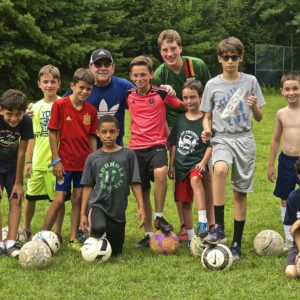 Boys playing football in summer camp