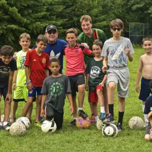 Boys playing football in summer camp
