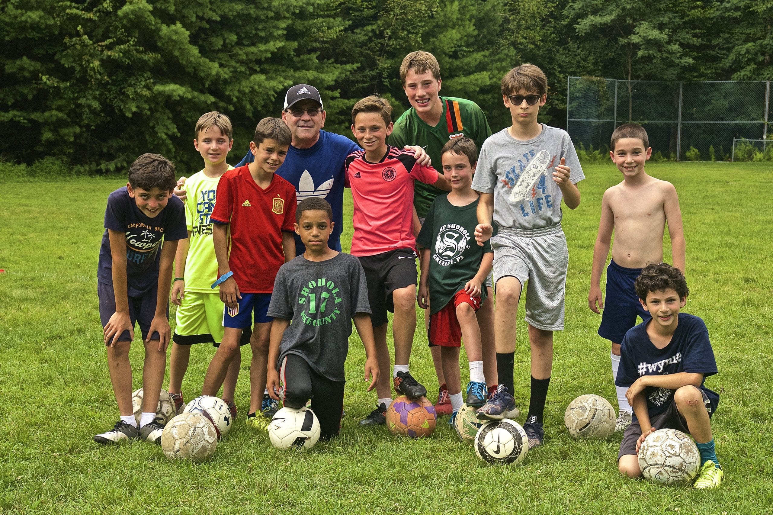 Boys playing football in summer camp