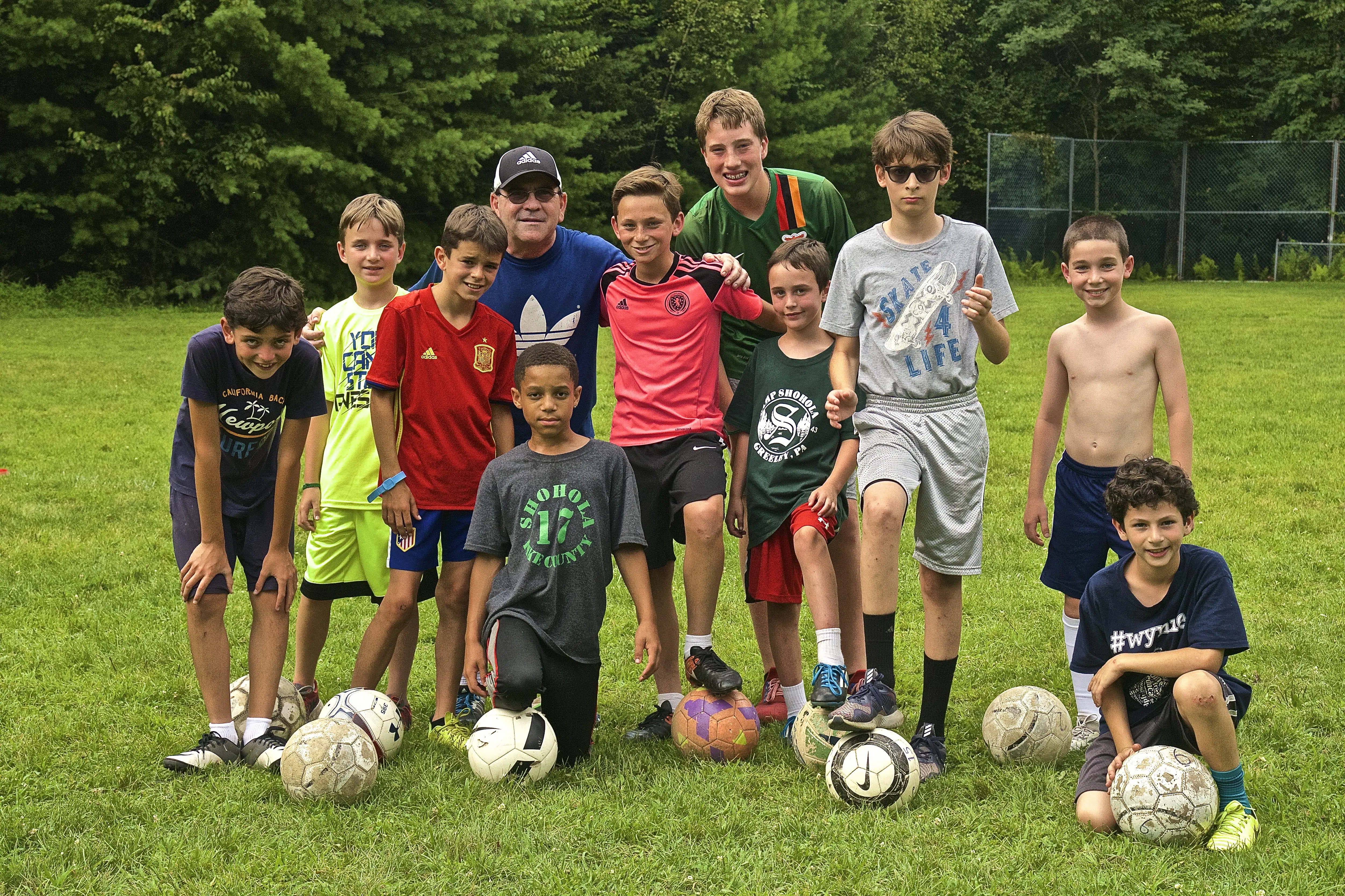 Boys playing football in summer camp