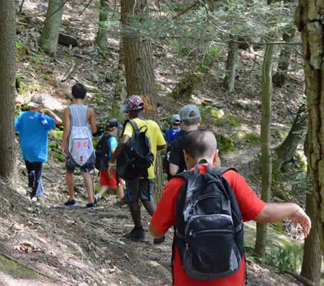 Young boys engaging in an outdoor experience as provided at Camp Shohola, a summer camp for boys in Pennsylvania.