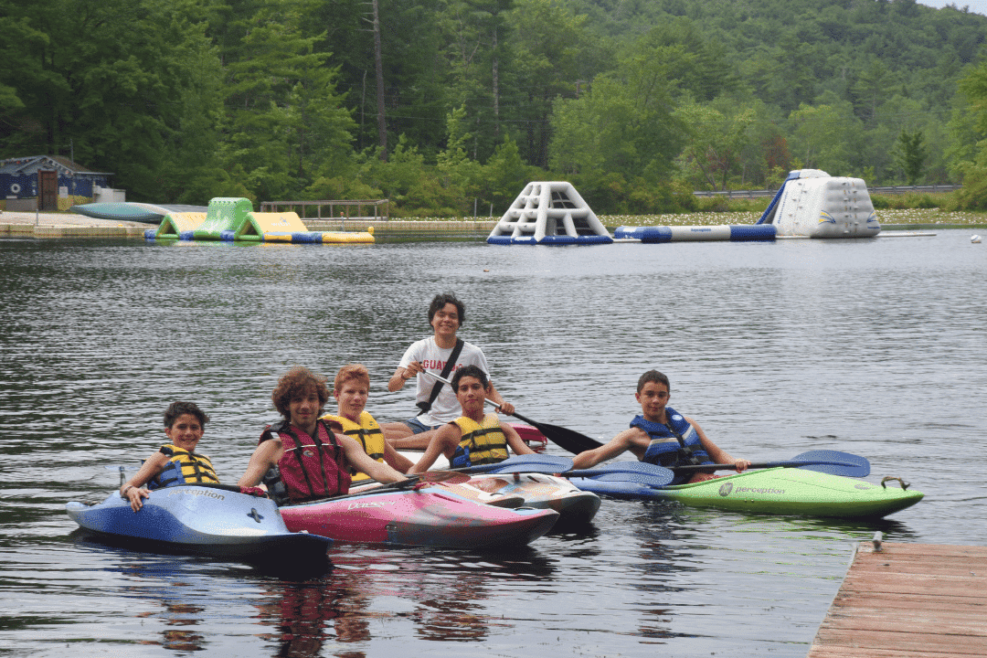 campers floating on lake water tubes