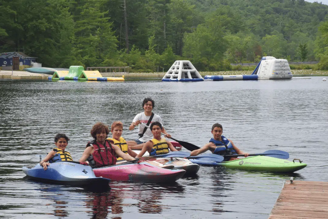 campers floating on lake water tubes