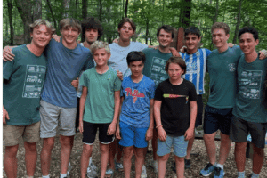 Campers and counselors smiling in a group photo at summer camp