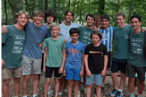 Campers and counselors smiling in a group photo at summer camp