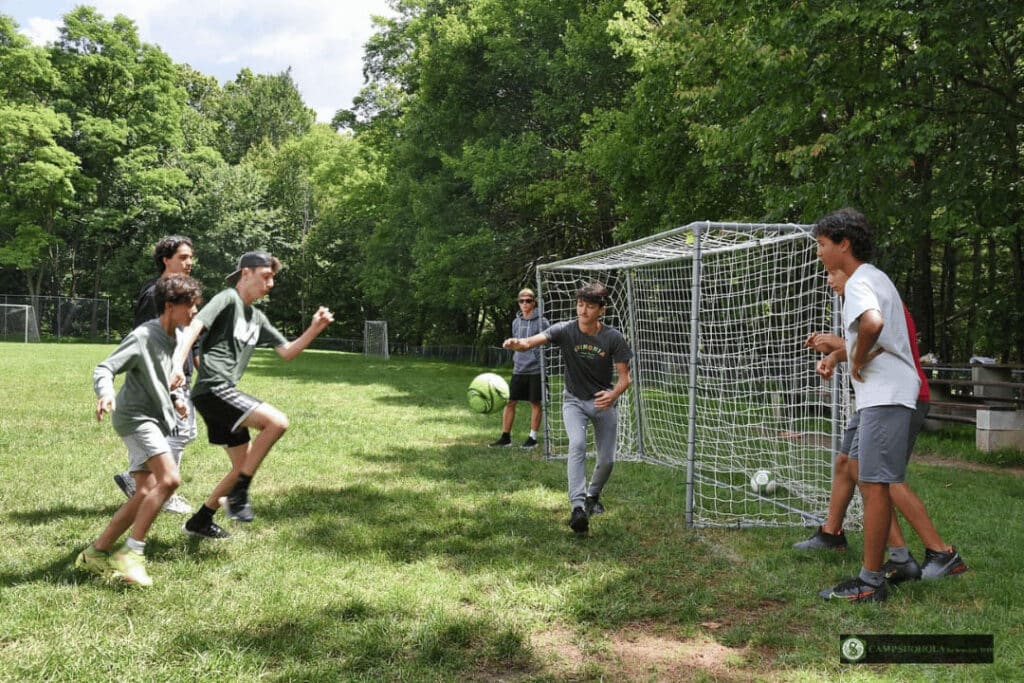Teen Campers Playing Soccer At Camp Shohola For Boys