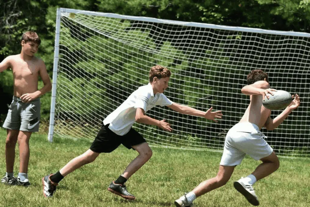 boys practicing summer camp sports during a soccer drill