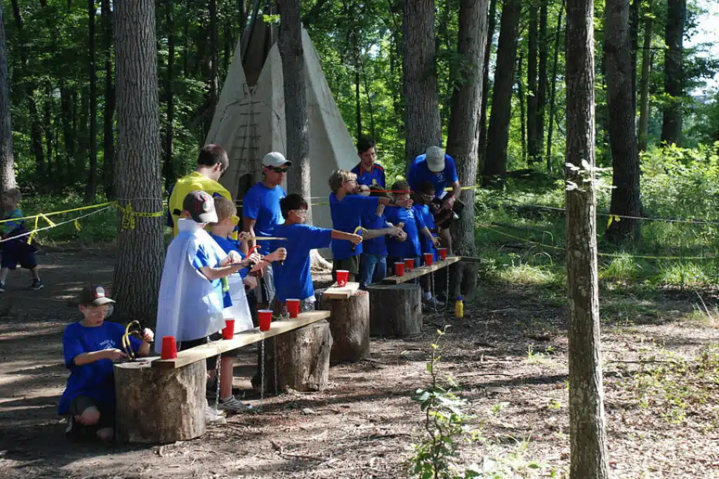 Boys participating in outdoor target game activity at summer camp