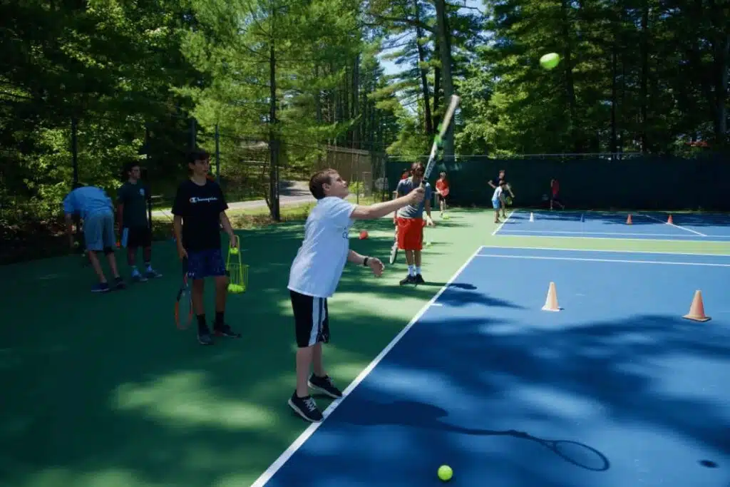 Campers learning teamwork skills at boys summer camp activity