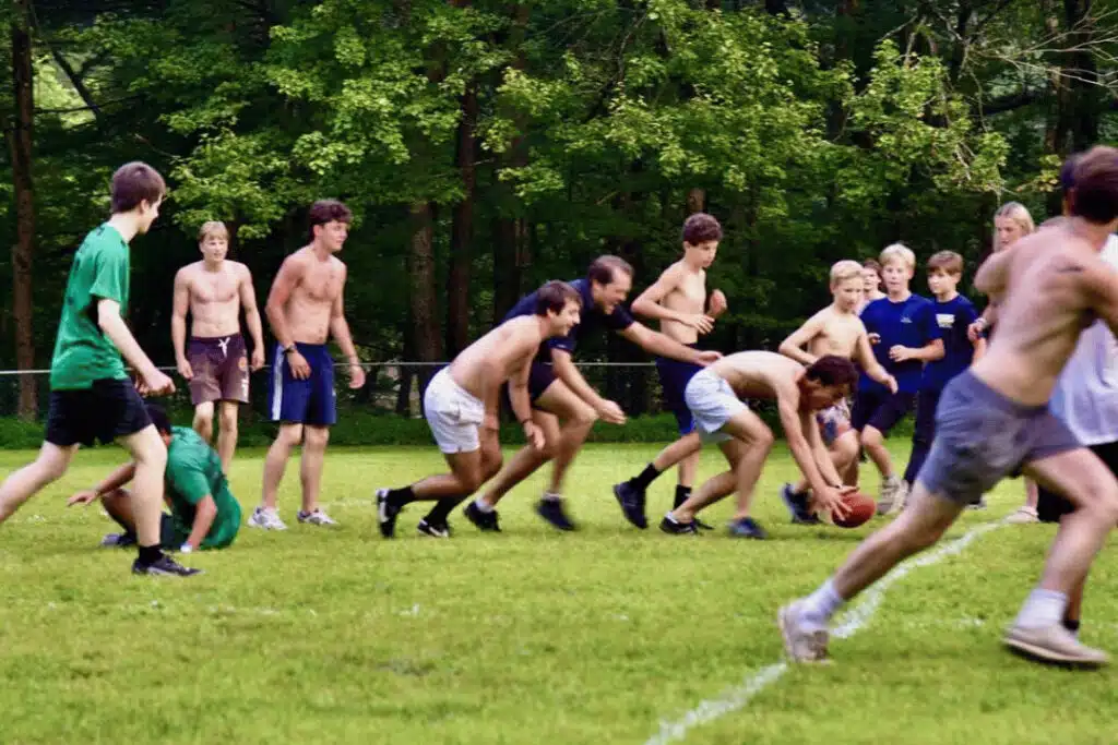 boys participating in outdoor adventure and team activities at sleepaway camp environment