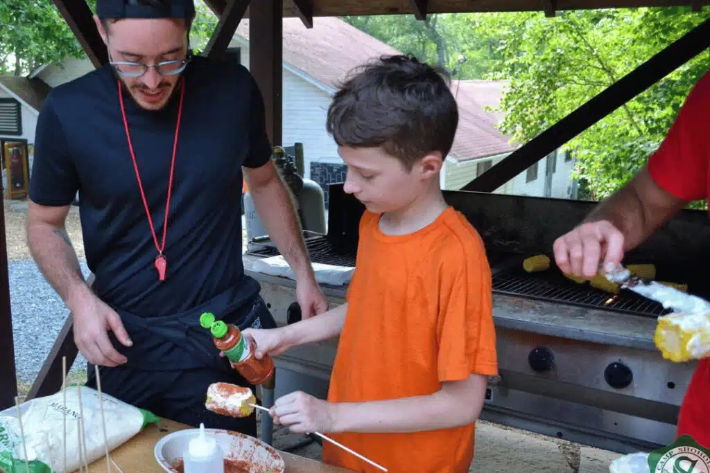 youth development camp hands-on learning with counselor teaching responsibility and independence